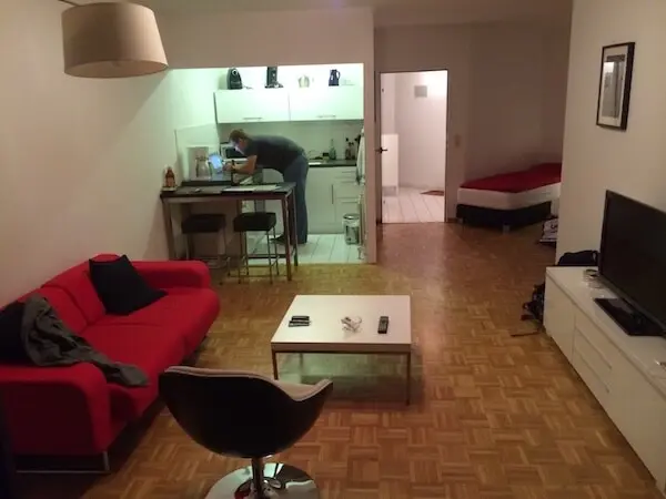 Small flat with a couch, coffee table, kitchen, and bed